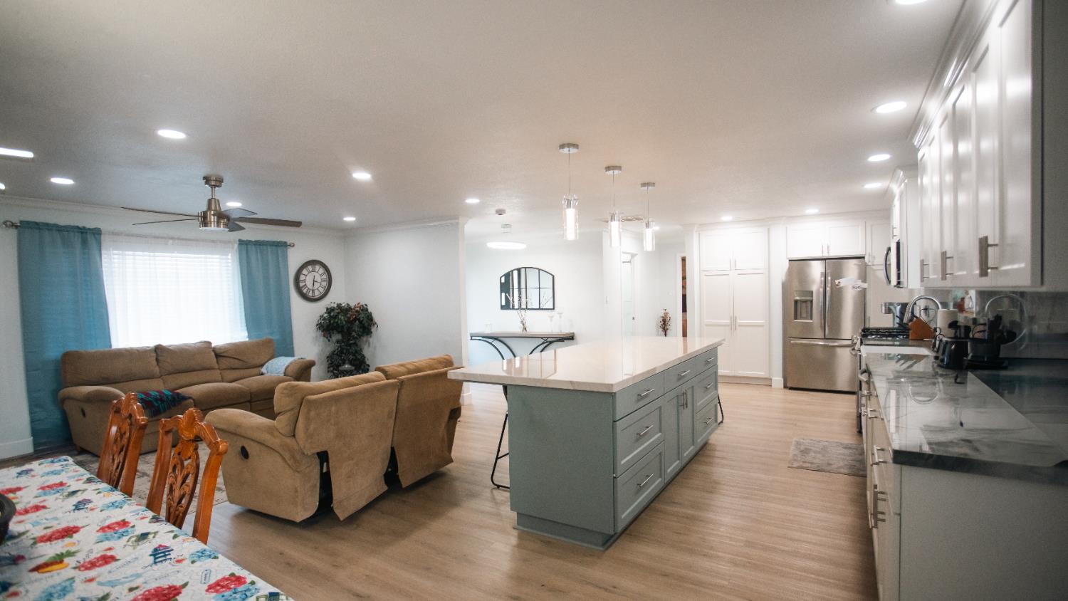9115 East Southland Road Manteca, CA 95336 - Photo 6 of 52 a large living room with stainless steel appliances kitchen island granite countertop furniture and a kitchen view