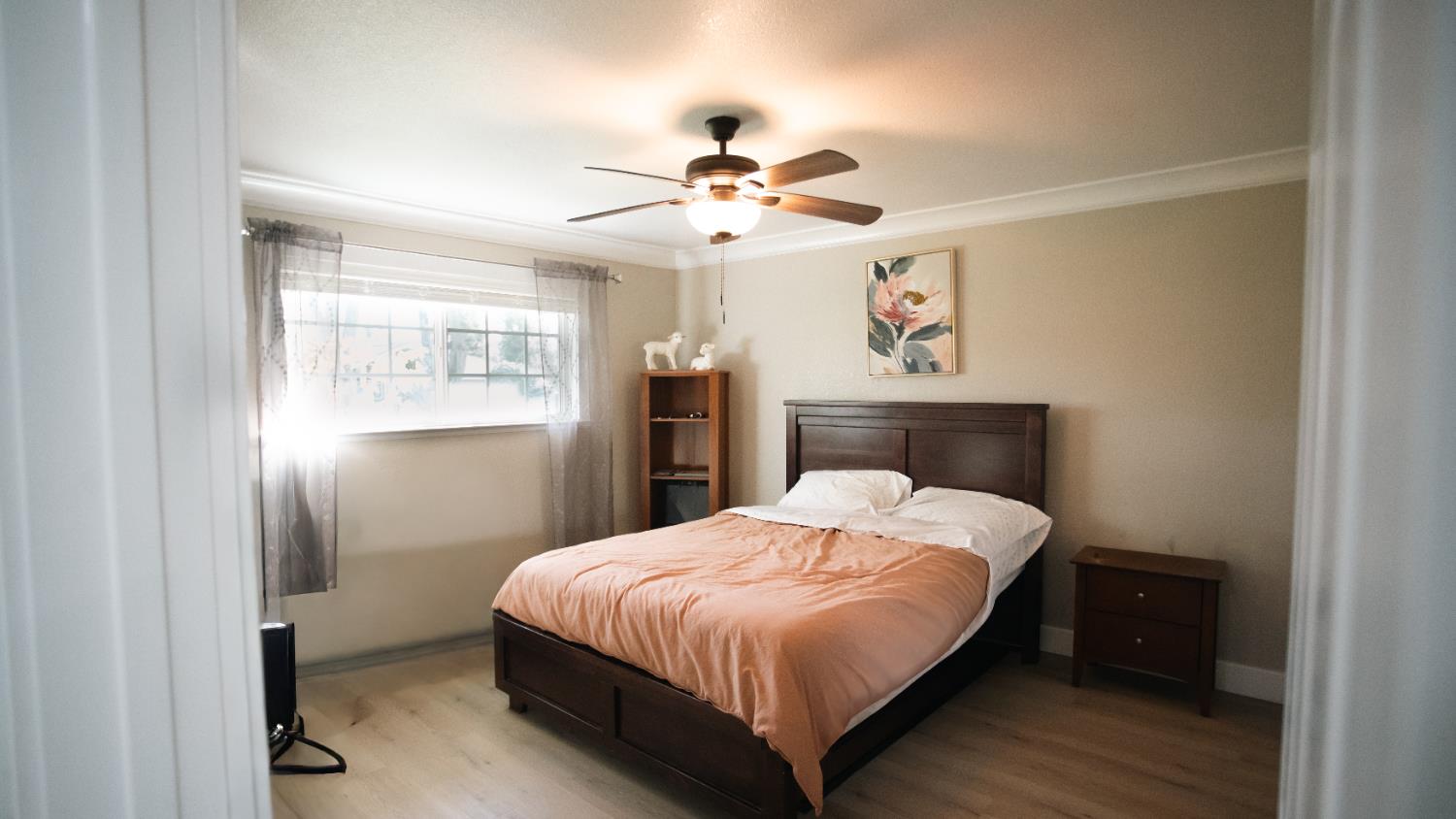 9115 East Southland Road Manteca, CA 95336 - Photo 10 of 52 a bedroom with a bed and a chandelier