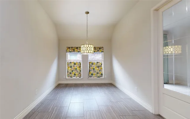 a kitchen with kitchen island granite countertop a refrigerator and a stove