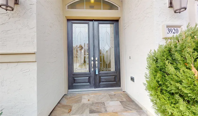 a view of a hallway with windows and chandelier