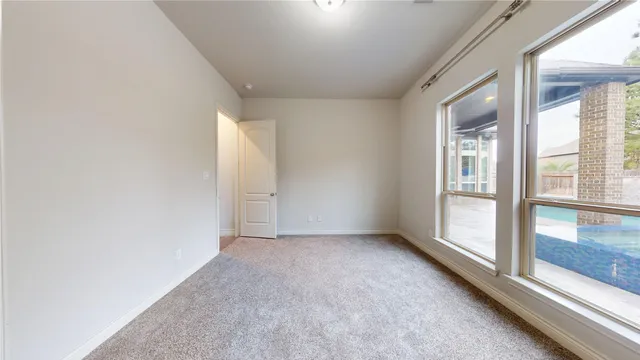 an empty room with windows and closet