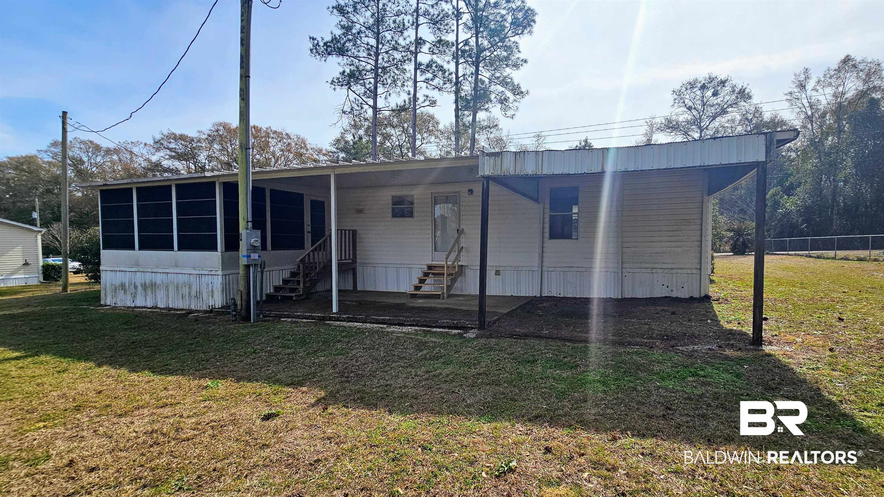18659 Bull Springs Road Robertsdale, AL 36567 - Photo 9 of 25 Back of house with a sunroom and a yard