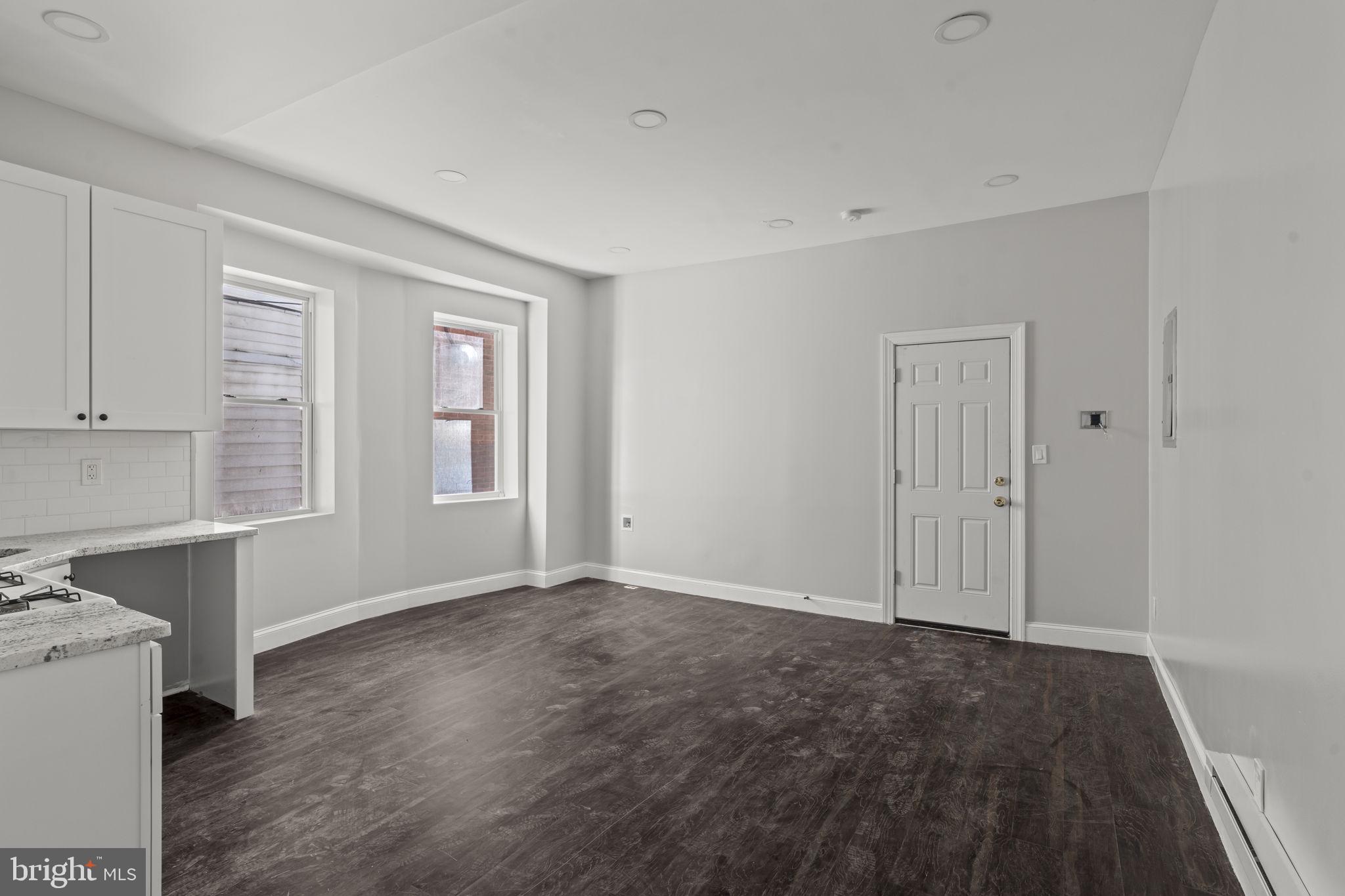 5237 Chester Avenue, Unit 3 Philadelphia, PA 19143 - Photo 13 of 35 a view of an empty room with window and wooden floor