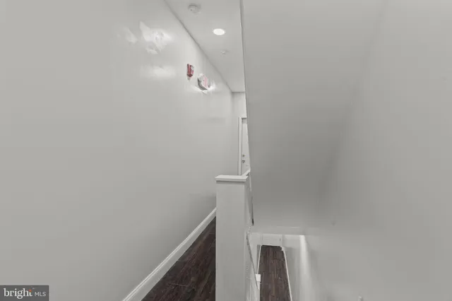 a open kitchen with white cabinets and wooden floor
