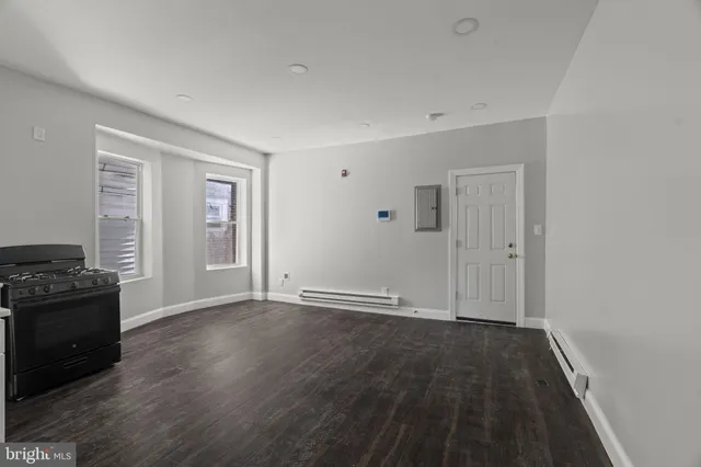 a bathroom with a toilet sink vanity and shower