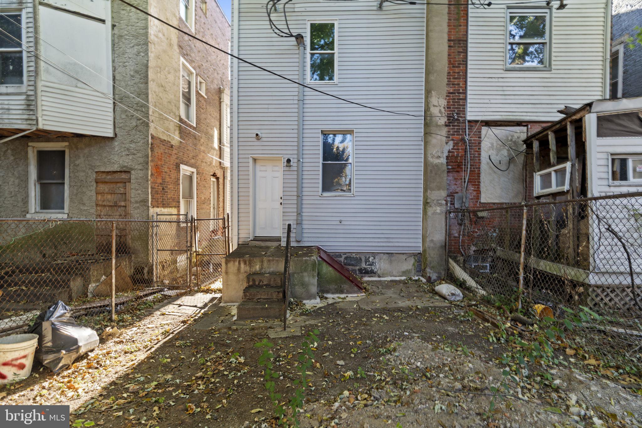 5237 Chester Avenue, Unit 3 Philadelphia, PA 19143 - Photo 32 of 35 a view of a house with a yard and sitting area