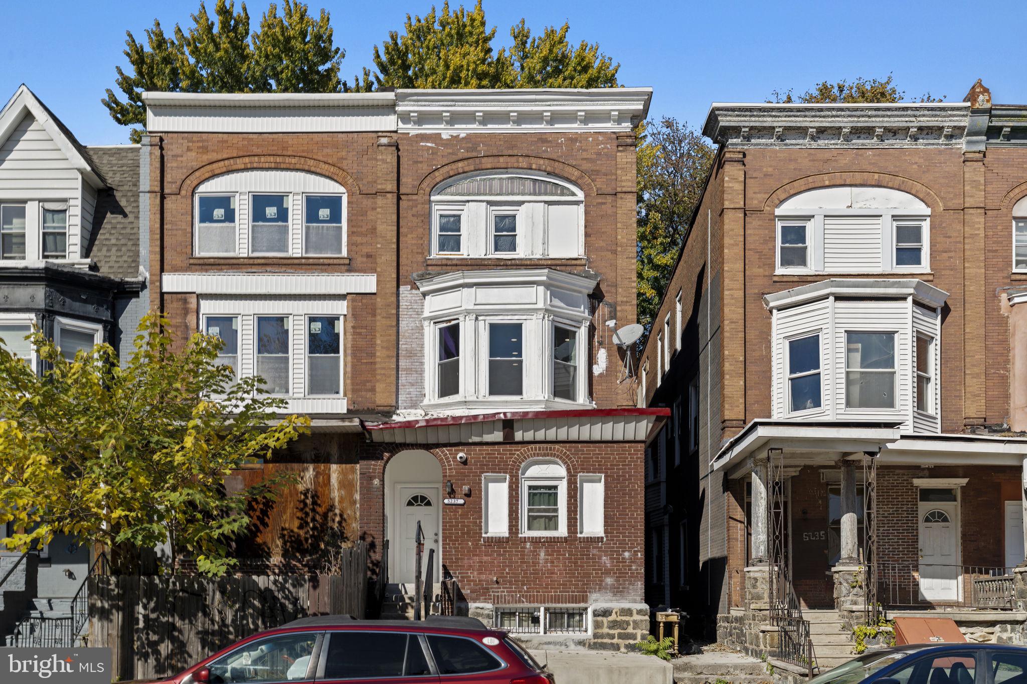 5237 Chester Avenue, Unit 3 Philadelphia, PA 19143 - Photo 5 of 35 a front view of a residential apartment building with a yard