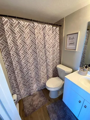 a white toilet sitting next to a bathroom sink