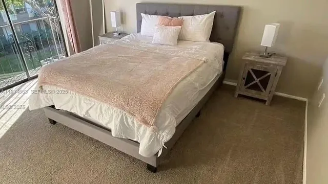 a bed sitting in a bedroom next to a larger window