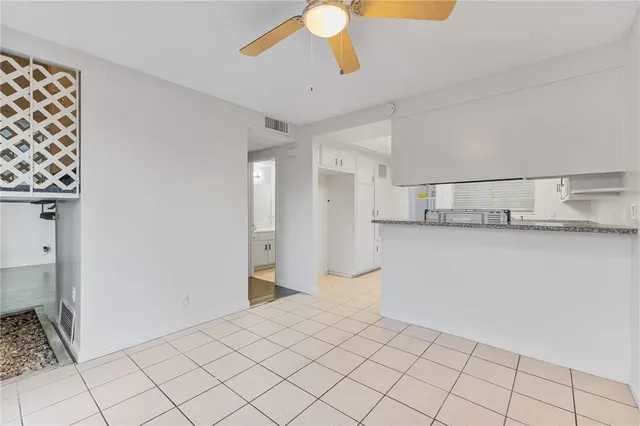 a kitchen with stainless steel appliances granite countertop a stove a sink and a white cabinets
