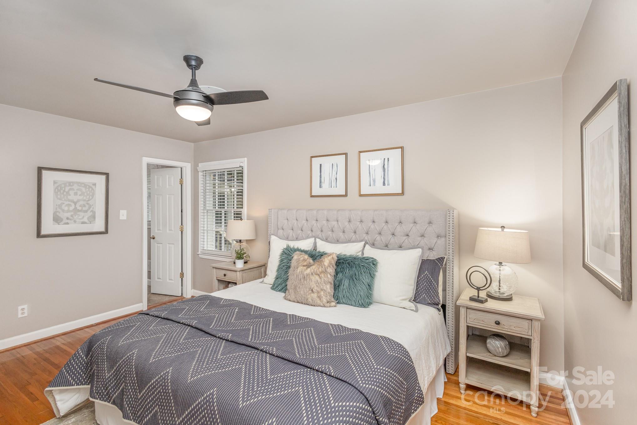 4011 Chandworth Road Charlotte, NC 28210 - Photo 17 of 30 a bedroom with a bed and a chandelier