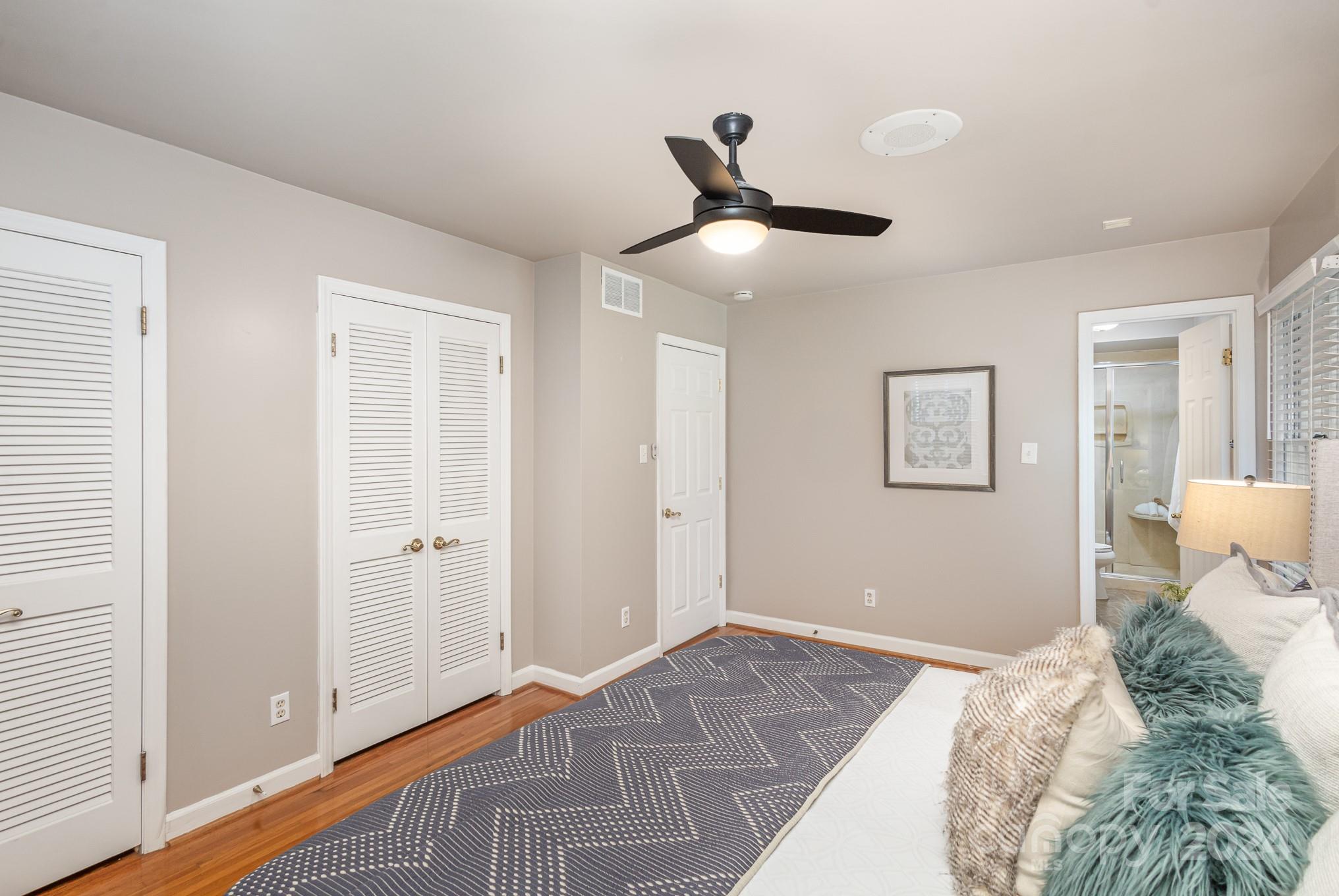 4011 Chandworth Road Charlotte, NC 28210 - Photo 18 of 30 a bedroom with a large bed and a chandelier