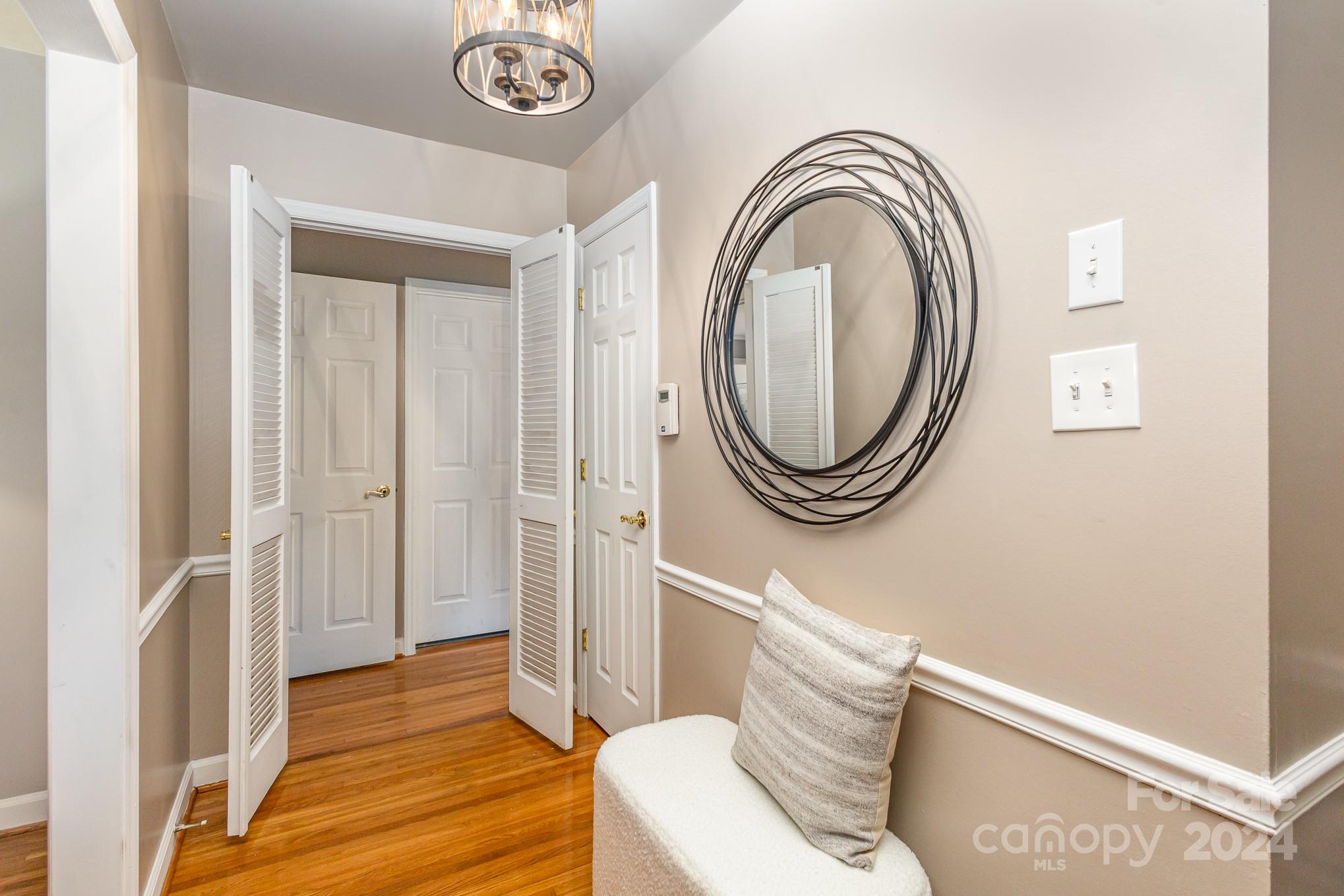 4011 Chandworth Road Charlotte, NC 28210 - Photo 2 of 30 a living room with a couch and a mirror