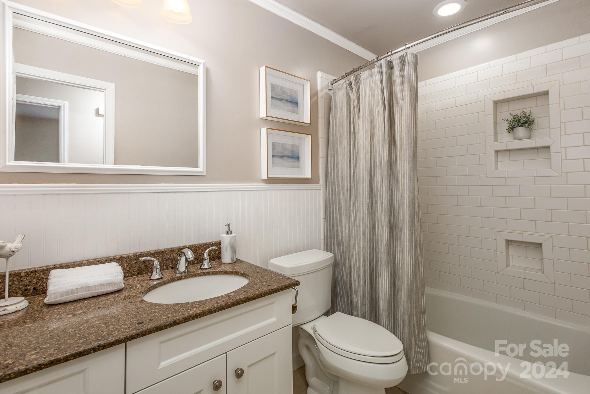 4011 Chandworth Road Charlotte, NC 28210 - Photo 21 of 30 a bathroom with a granite countertop sink toilet and shower