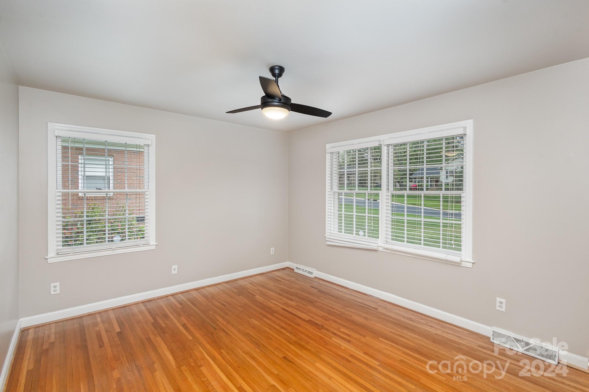 4011 Chandworth Road Charlotte, NC 28210 - Photo 22 of 30 a view of an empty room with wooden floor and a window
