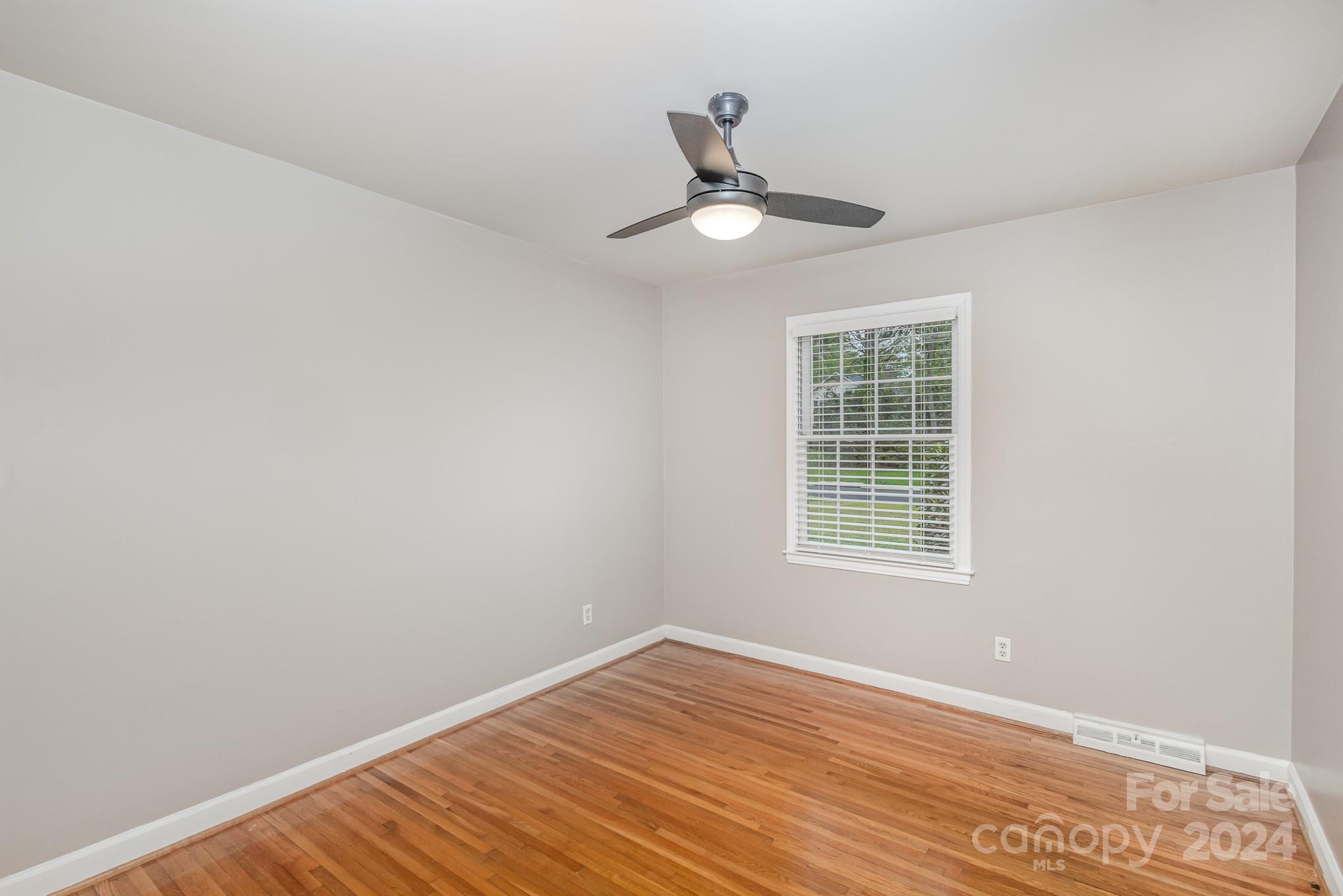 4011 Chandworth Road Charlotte, NC 28210 - Photo 23 of 30 a view of an empty room with wooden floor and a window
