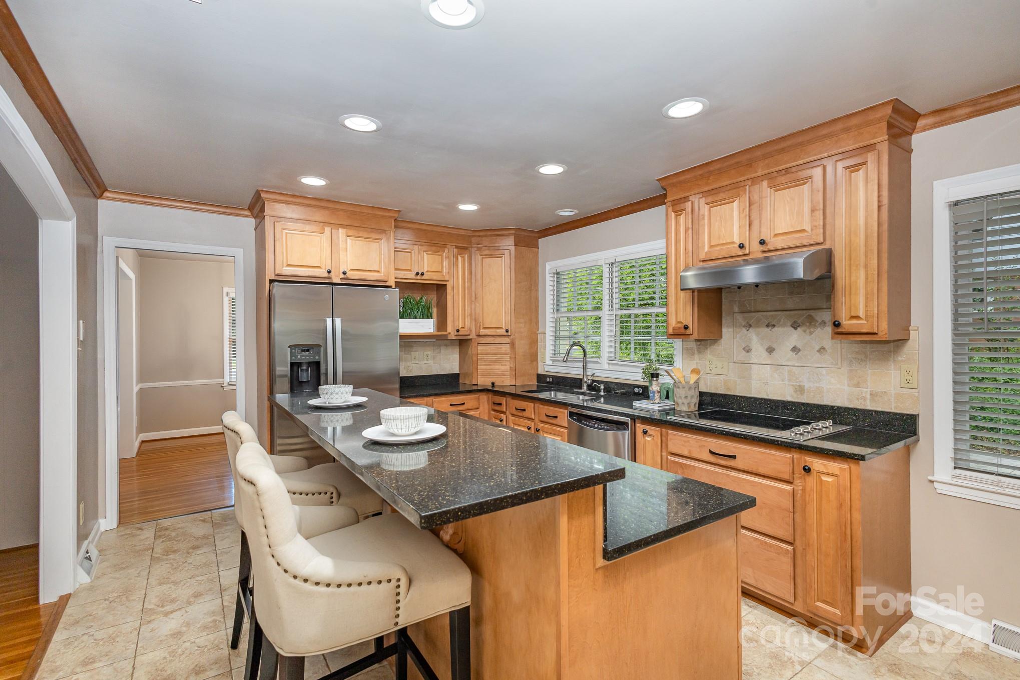 4011 Chandworth Road Charlotte, NC 28210 - Photo 8 of 30 a kitchen with kitchen island granite countertop a sink and counter space
