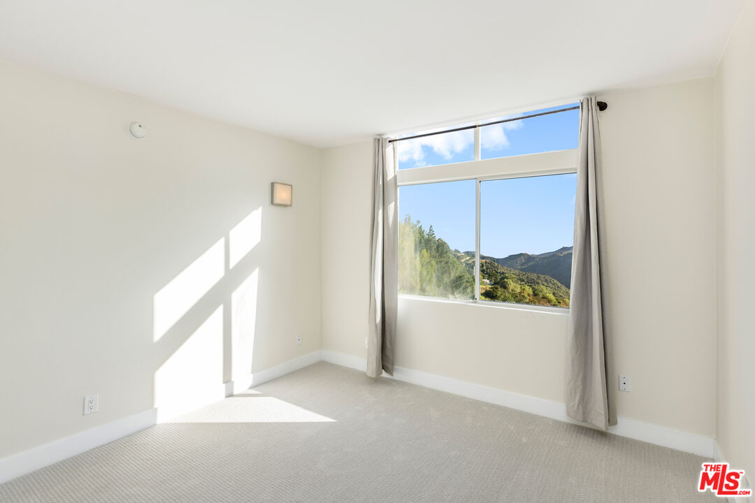 2385 Roscomare Road, Unit F4 Los Angeles, CA 90077 - Photo 13 of 57 a view of an empty room and window