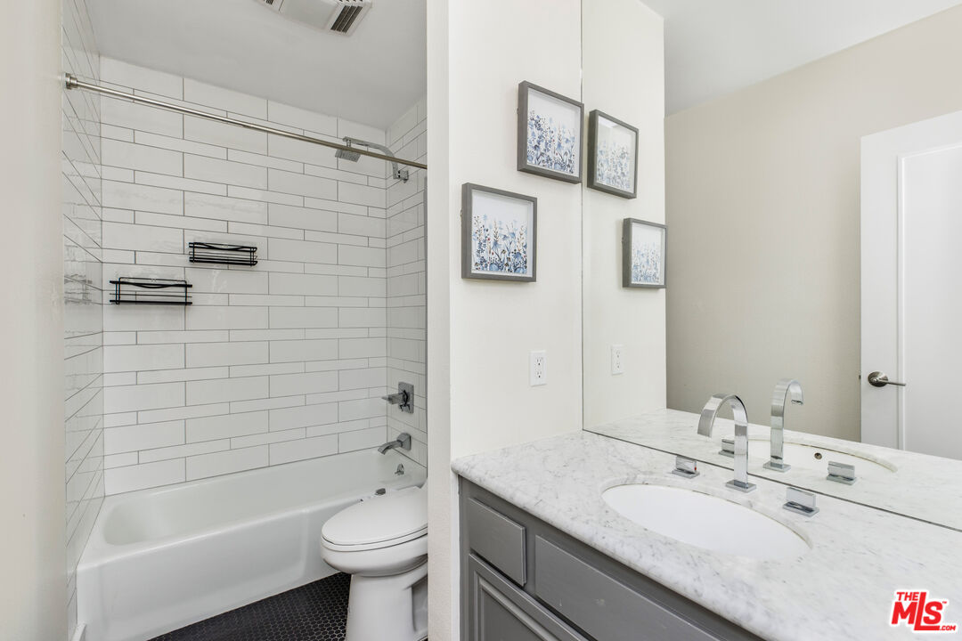 2385 Roscomare Road, Unit F4 Los Angeles, CA 90077 - Photo 16 of 57 a bathroom with a granite countertop toilet sink and shower
