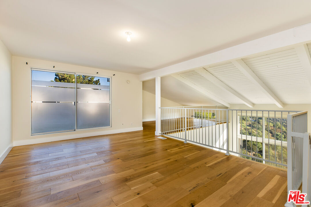2385 Roscomare Road, Unit F4 Los Angeles, CA 90077 - Photo 22 of 57 a view of an empty room with wooden floor