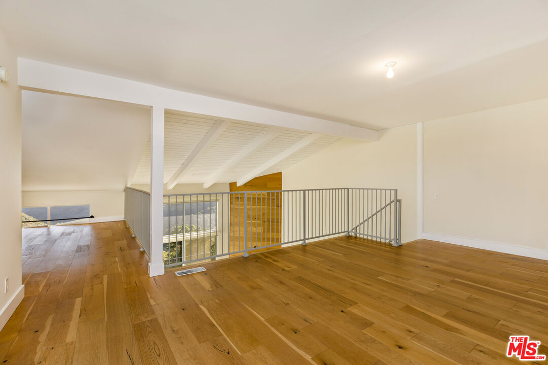 2385 Roscomare Road, Unit F4 Los Angeles, CA 90077 - Photo 23 of 57 a view of an empty room with wooden floor
