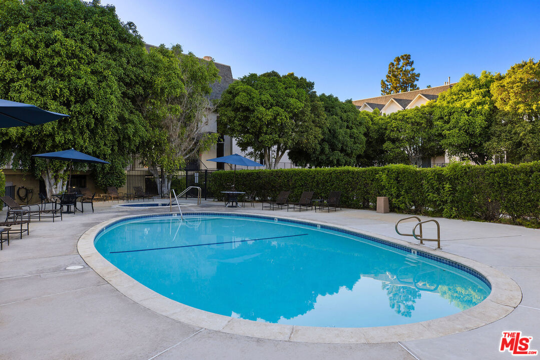 2385 Roscomare Road, Unit F4 Los Angeles, CA 90077 - Photo 31 of 57 a view of a swimming pool and lounge chair