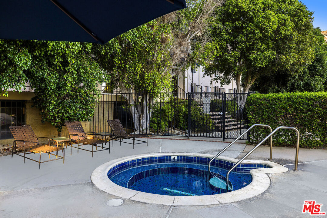2385 Roscomare Road, Unit F4 Los Angeles, CA 90077 - Photo 33 of 57 a view of swimming pool with outdoor seating and plants