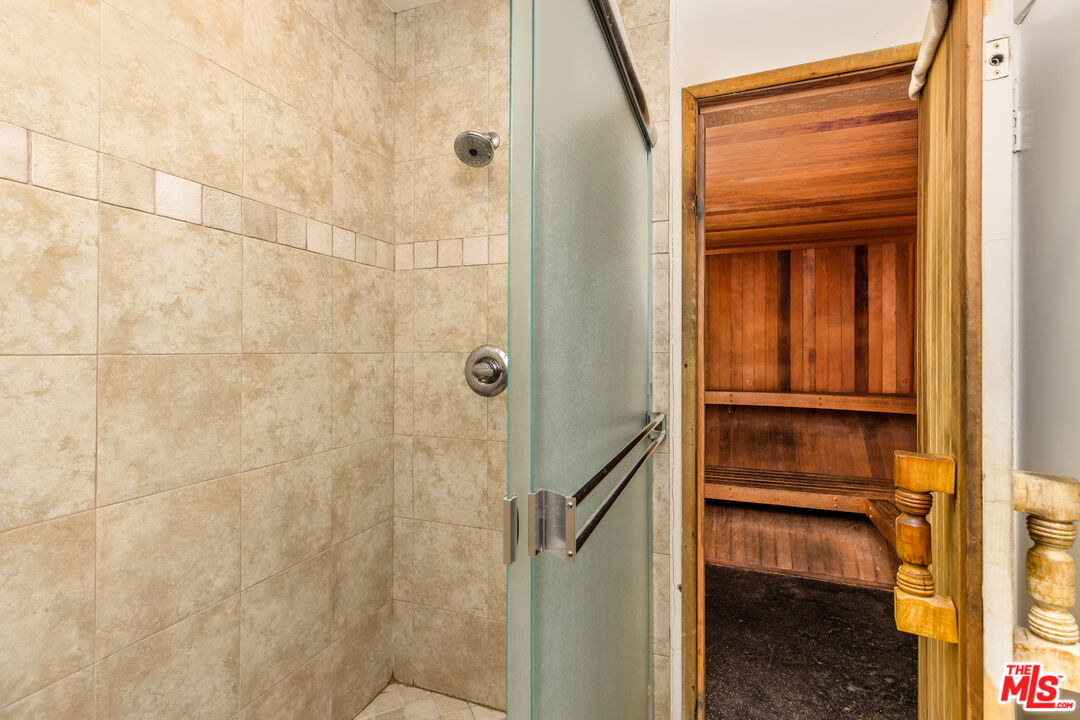 2385 Roscomare Road, Unit F4 Los Angeles, CA 90077 - Photo 38 of 57 a bathroom with a glass door