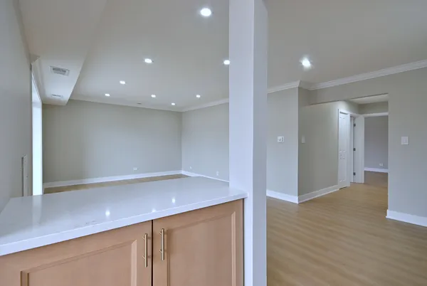 a view of an empty room with wooden floor