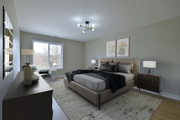 a spacious bedroom with a bed a couch and a large window