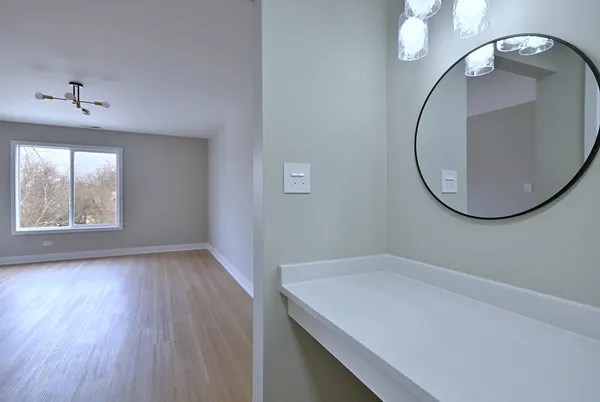 a view of a bathroom with a sink and a mirror