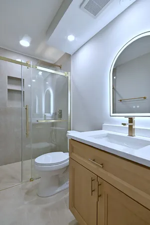 a bathroom with a sink a toilet and mirror