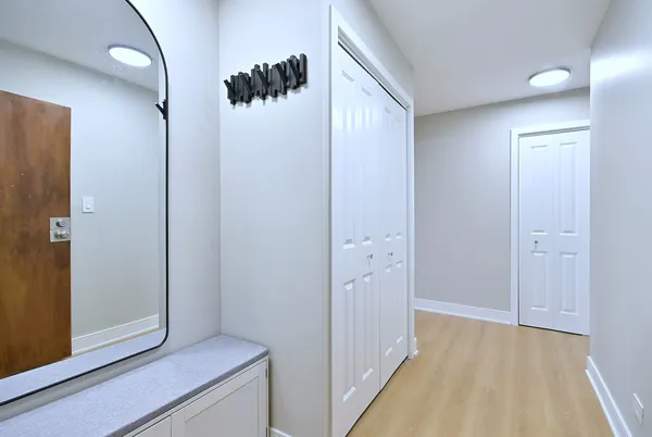 a view of hallway with wooden floor