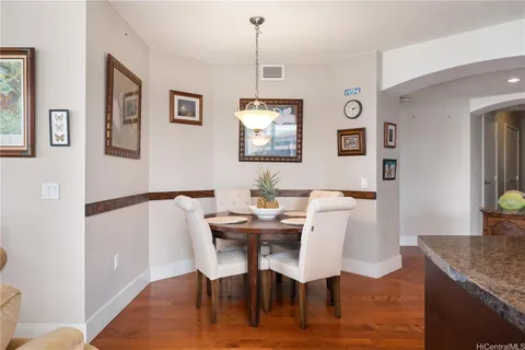 a view of a dining room with furniture and wooden floor