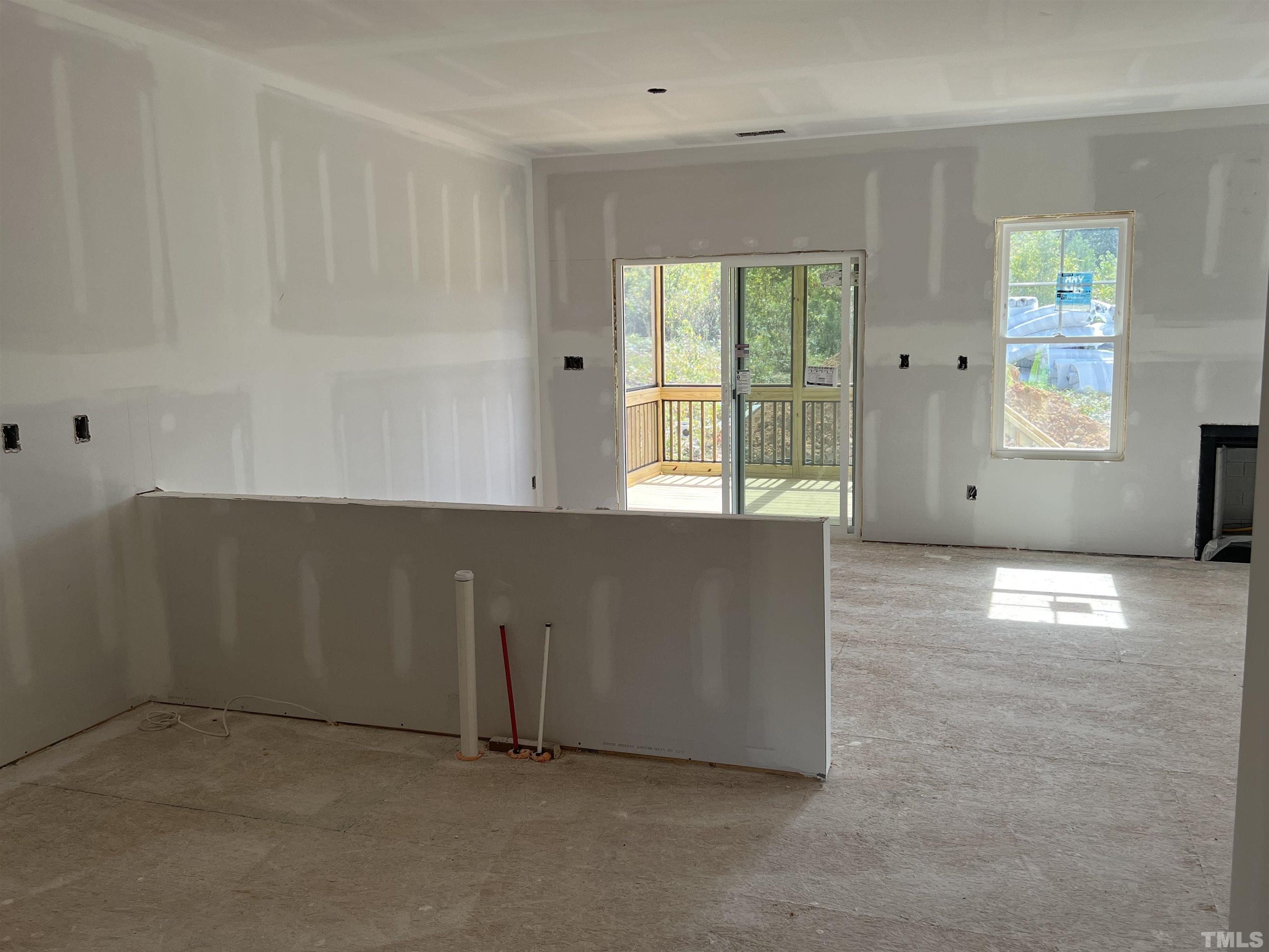 4450 Debnam Road Zebulon, NC 27597 - Photo 4 of 6 an empty room with windows