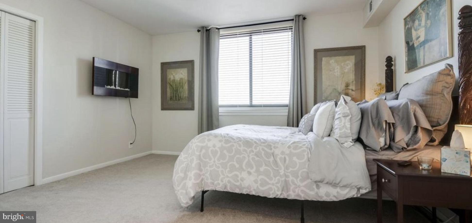 5505 Seminary Road, Unit 914N Falls Church, VA 22041 - Photo 14 of 29 a bedroom with a bed and flat screen tv