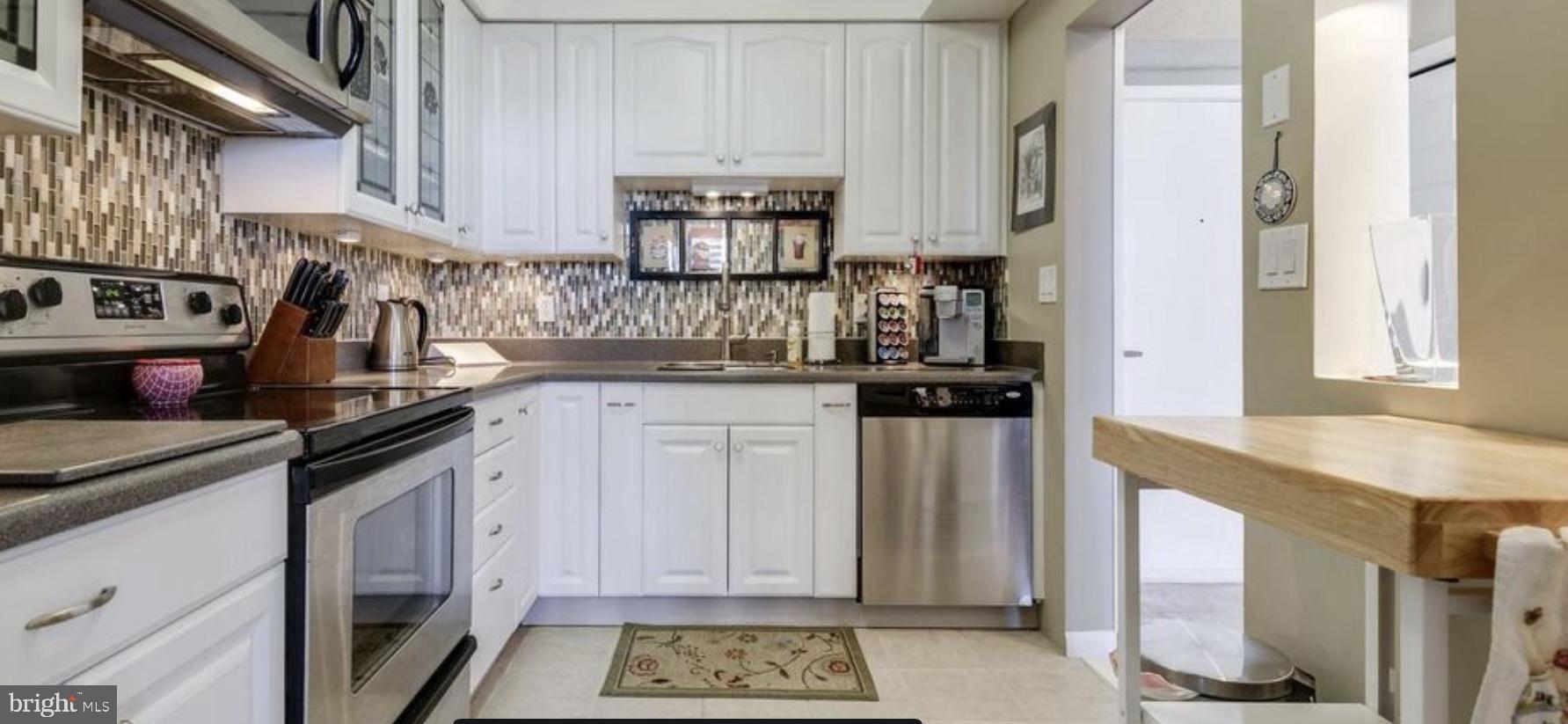 5505 Seminary Road, Unit 914N Falls Church, VA 22041 - Photo 15 of 29 a kitchen with stainless steel appliances granite countertop a stove a sink and a refrigerator