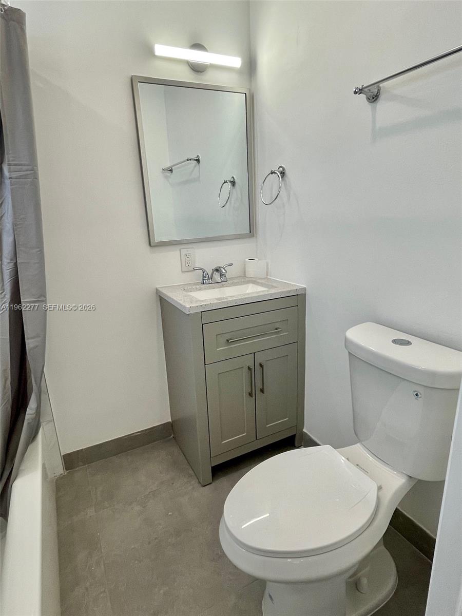 5701 Northwest 28th Street, Unit 13 Lauderhill, FL 33313 - Photo 14 of 34 a bathroom with a granite countertop toilet sink and mirror