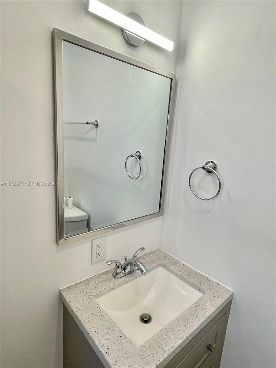 5701 Northwest 28th Street, Unit 13 Lauderhill, FL 33313 - Photo 16 of 34 a bathroom with a sink and mirror