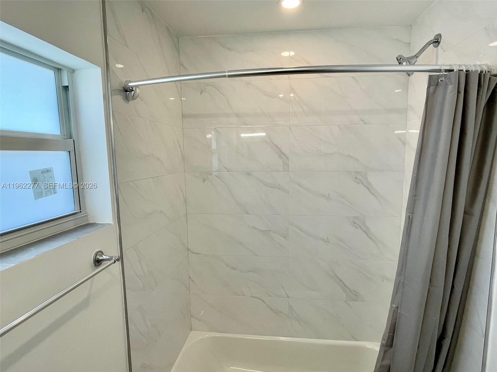 5701 Northwest 28th Street, Unit 13 Lauderhill, FL 33313 - Photo 19 of 34 a bathroom with a shower and a sink