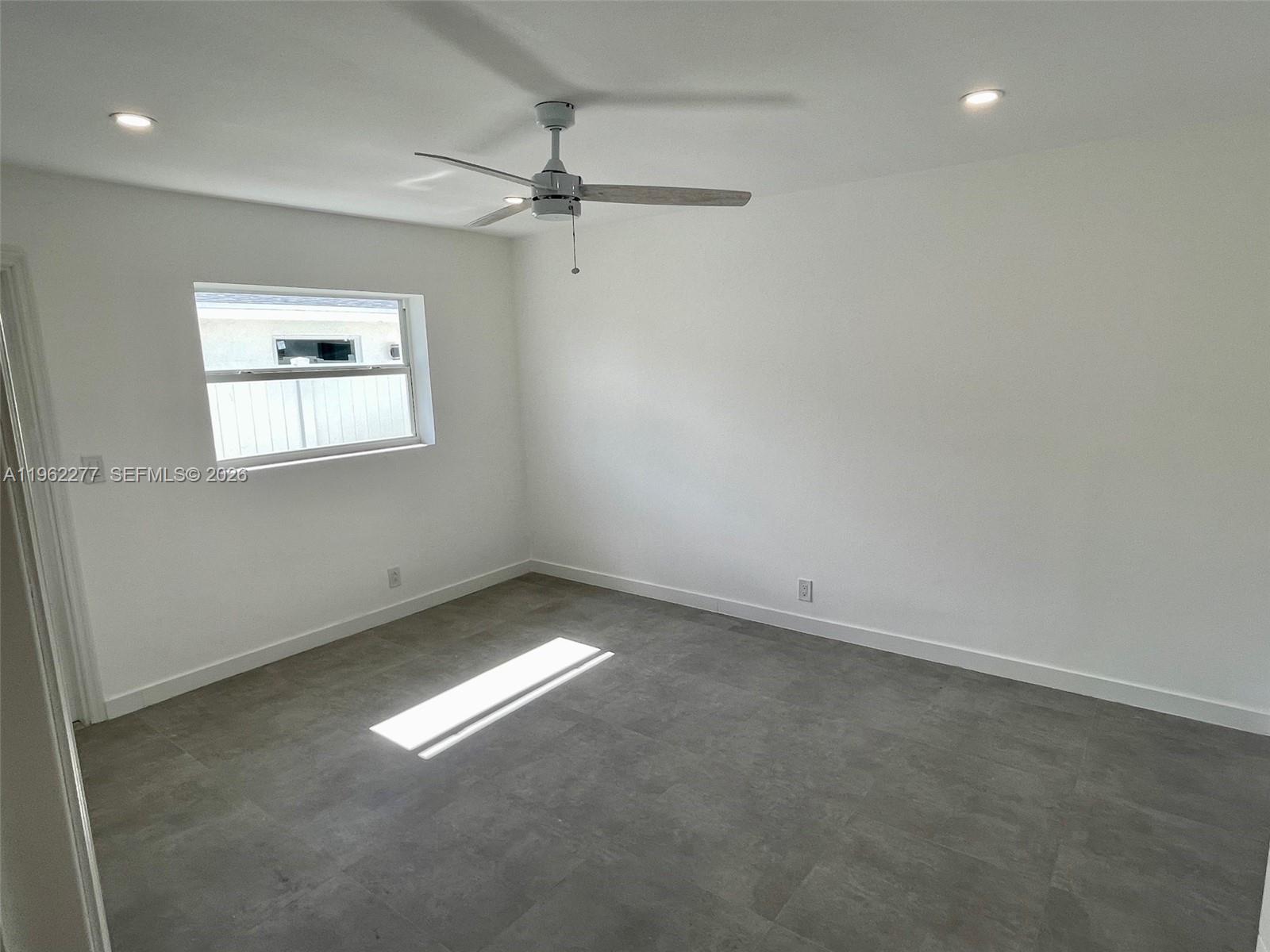 5701 Northwest 28th Street, Unit 13 Lauderhill, FL 33313 - Photo 22 of 34 an empty room with a window