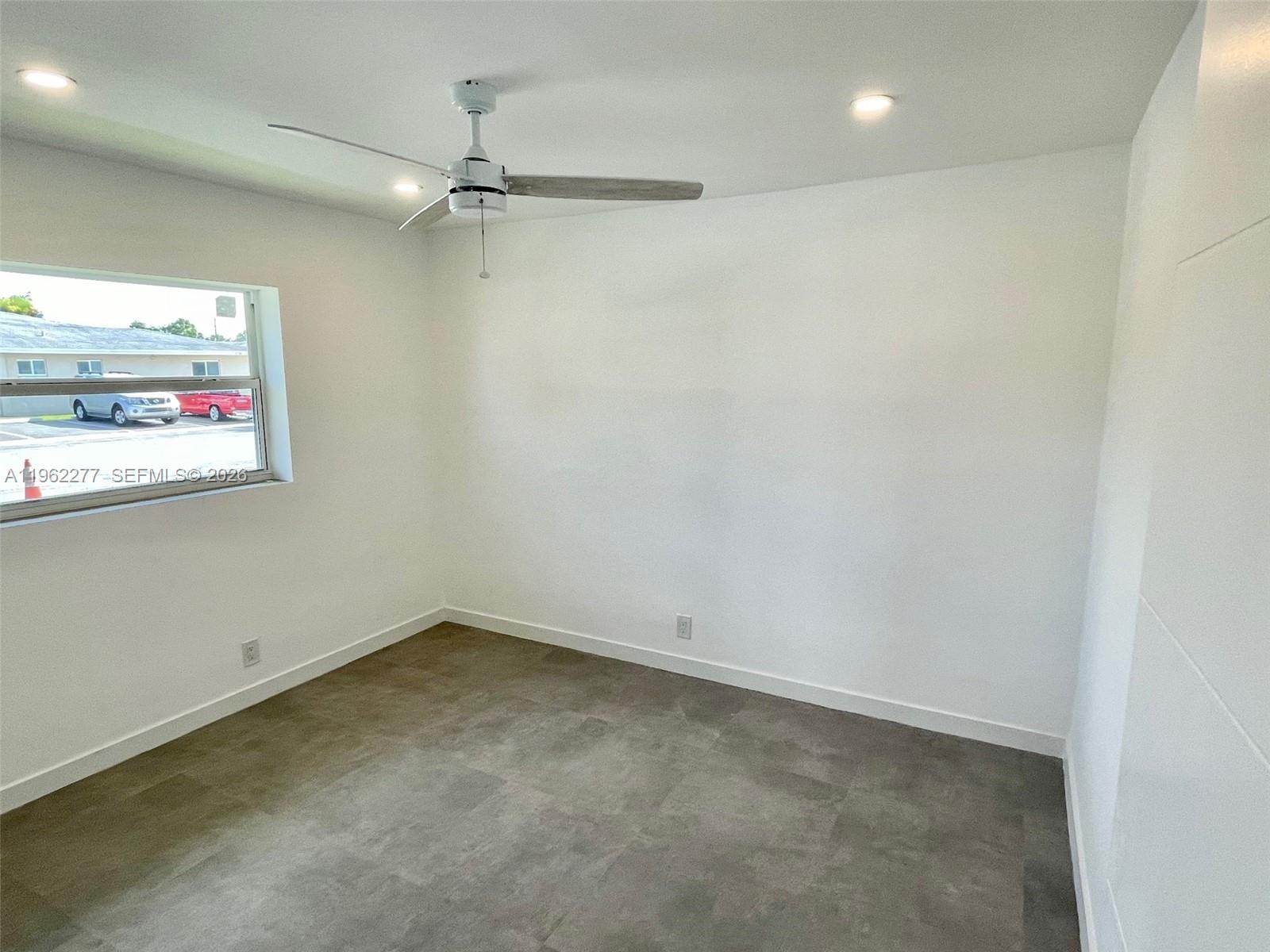 5701 Northwest 28th Street, Unit 13 Lauderhill, FL 33313 - Photo 23 of 34 an empty room with windows