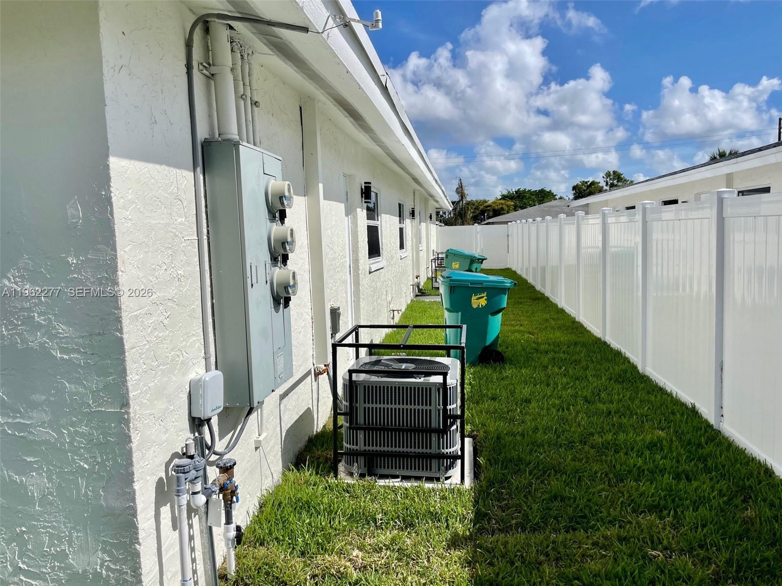 5701 Northwest 28th Street, Unit 13 Lauderhill, FL 33313 - Photo 29 of 34 a backyard of a house with table and chairs