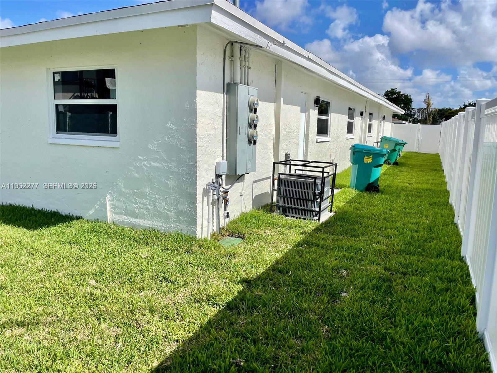 5701 Northwest 28th Street, Unit 13 Lauderhill, FL 33313 - Photo 31 of 34 a backyard of a house with lots of green space