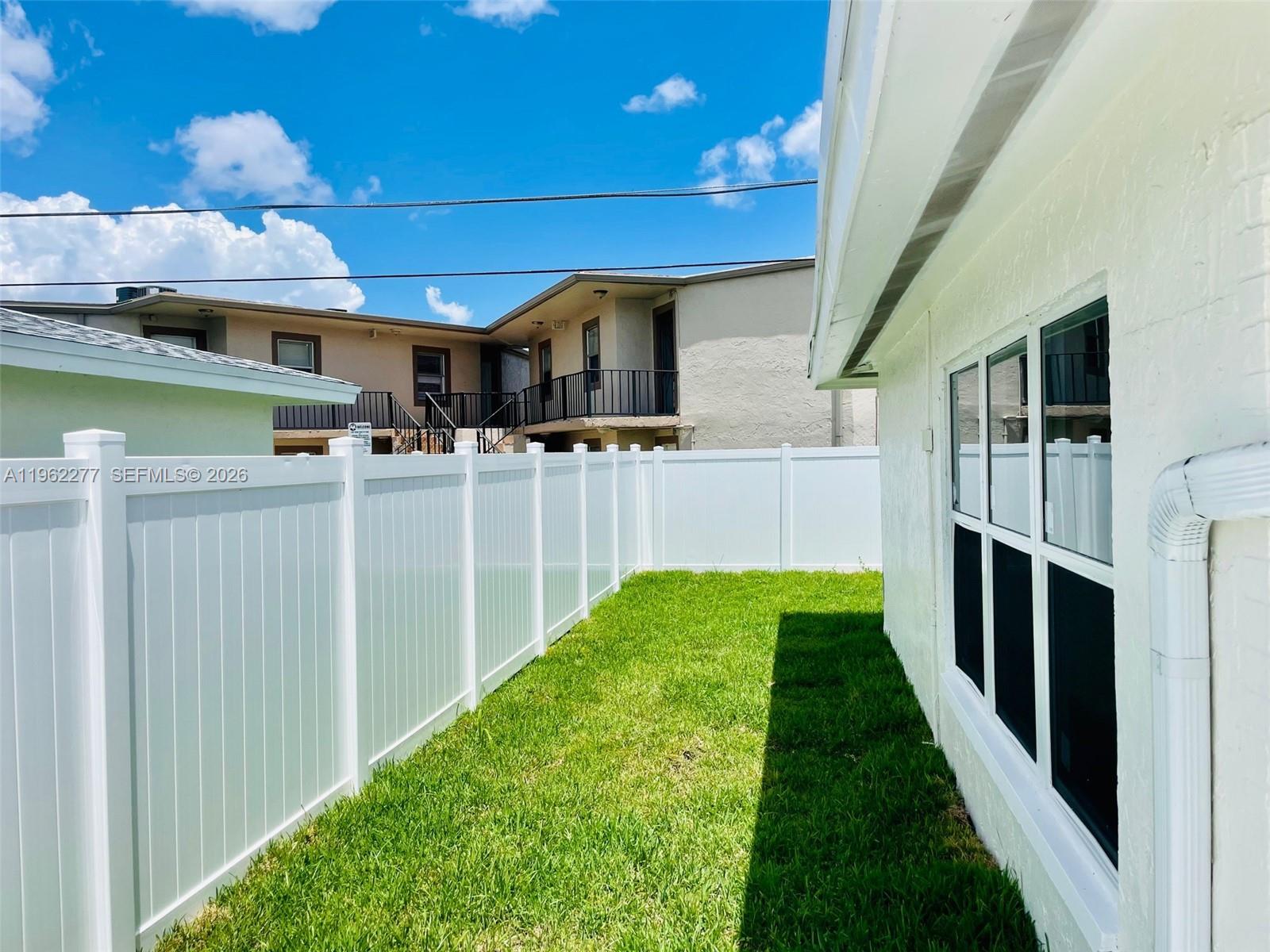 5701 Northwest 28th Street, Unit 13 Lauderhill, FL 33313 - Photo 32 of 34 a view of a backyard with table and chairs