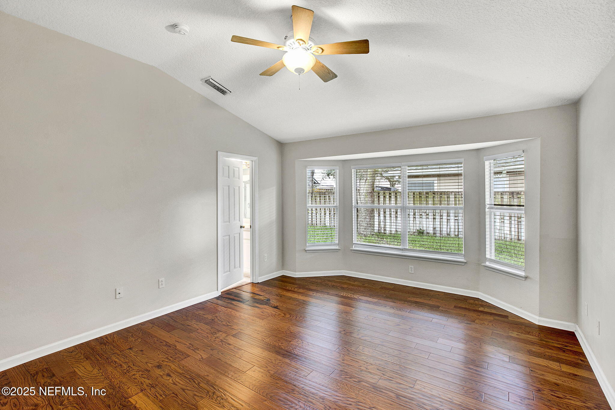 2105 South Cranbrook Avenue St. Augustine, FL 32092 - Photo 13 of 23 a view of an empty room with wooden floor and a window