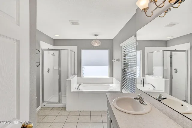 a bathroom with a tub sink and mirror