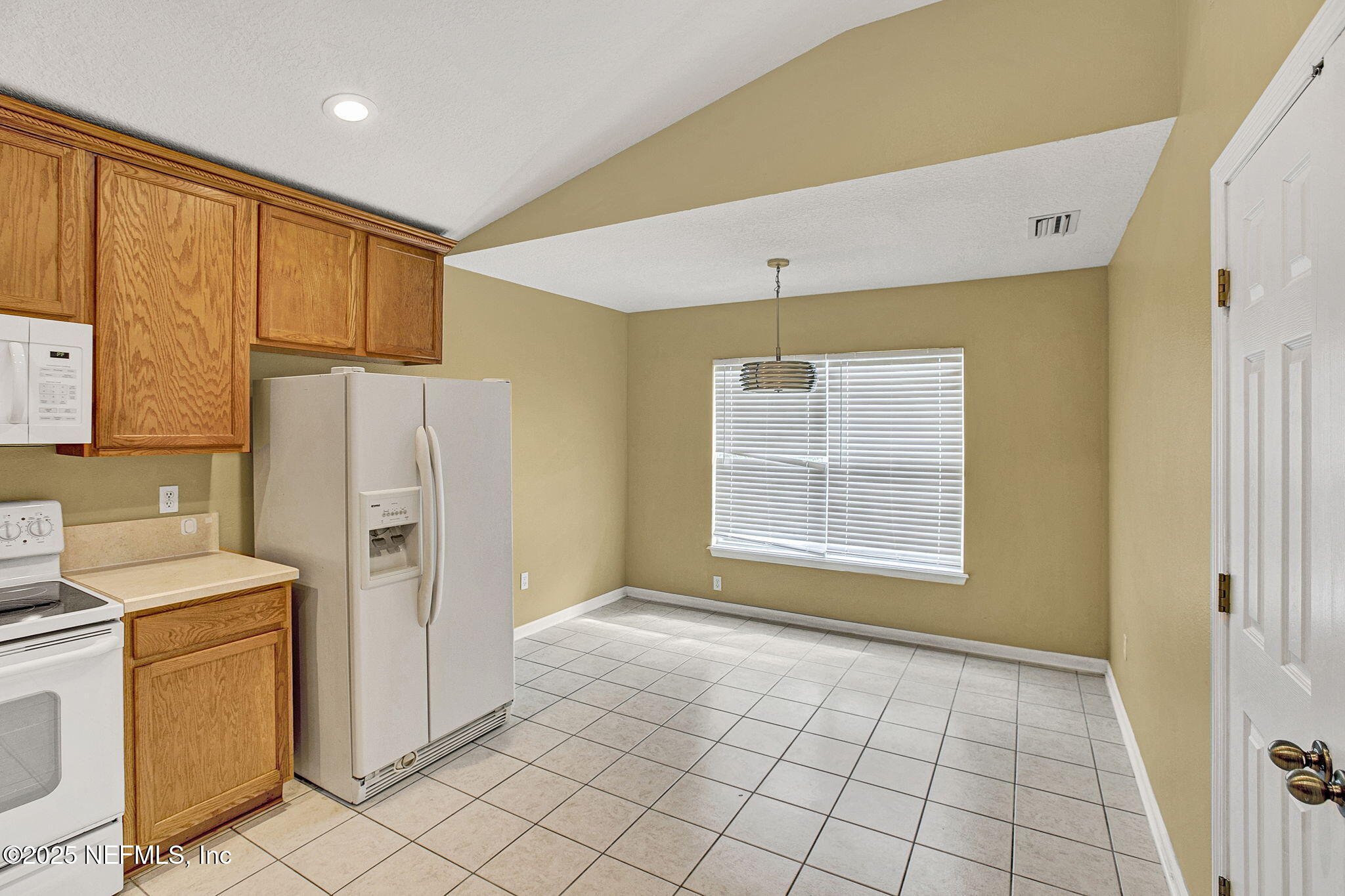 2105 South Cranbrook Avenue St. Augustine, FL 32092 - Photo 7 of 23 a kitchen with a refrigerator a stove top oven and cabinets