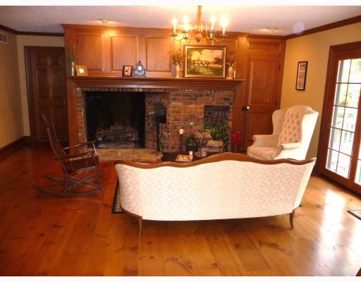 464 Hollow Road Darlington, PA 16115 - Photo 6 of 18 Living Room. Living room with custom wood paneling, storage closet and large, open hearth wood burning fireplace. Doors lead to rear deck.