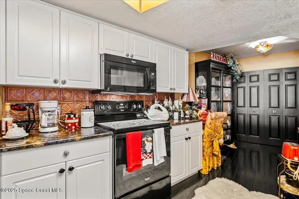 a kitchen with stainless steel appliances granite countertop a refrigerator and a stove